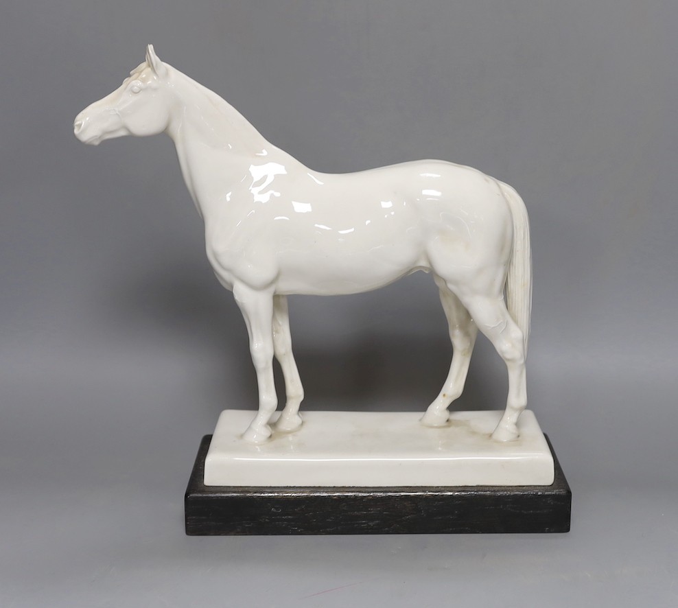 A Meissen model of a horse ‘Alchimist’ signed Erich Oehme 1935, on wooden stand 30cm high, crossed swords mark with to incised lines